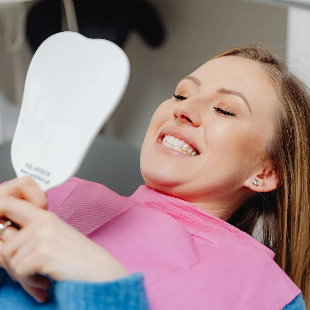 Woman sitting for a teeth whitening cosmetic treatment