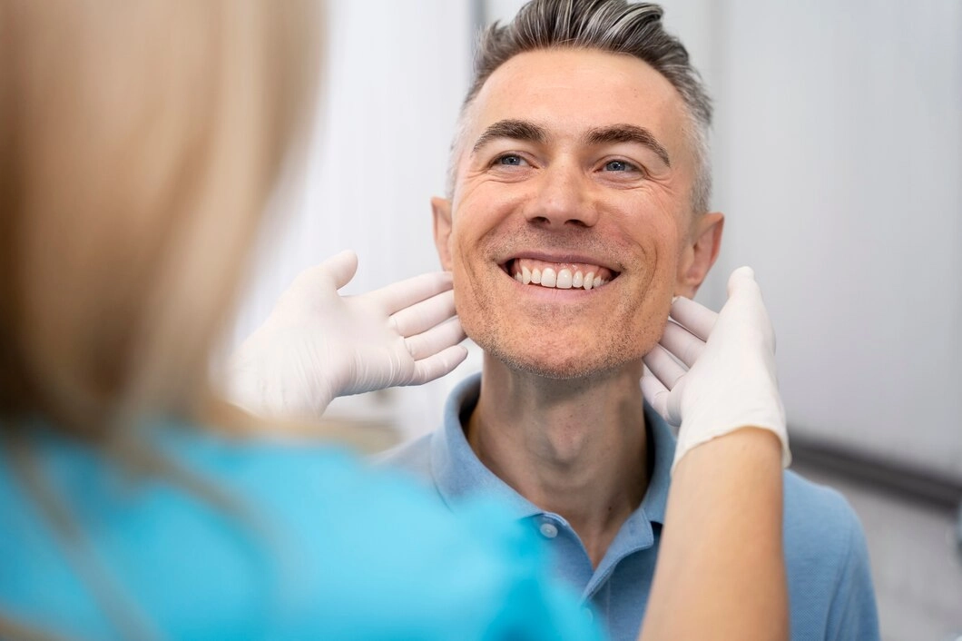 patient smiling after getting a dental crown