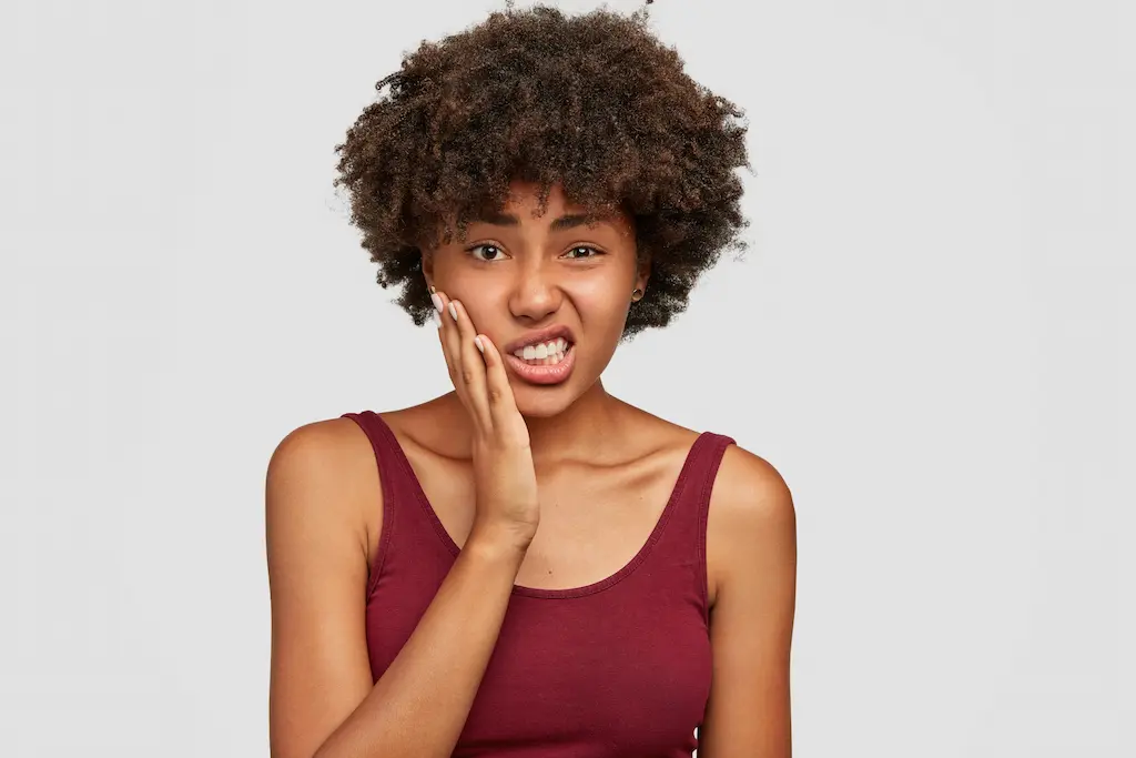 Woman in pain from grinding her teeth