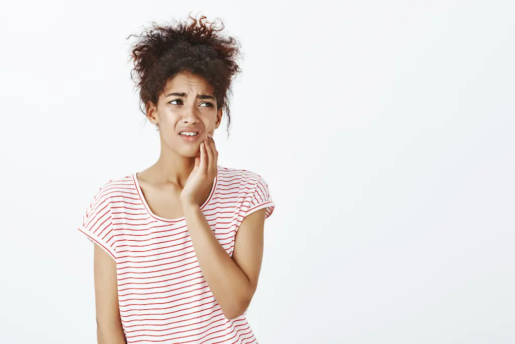 Patient experiencing jaw pain from teeth grinding